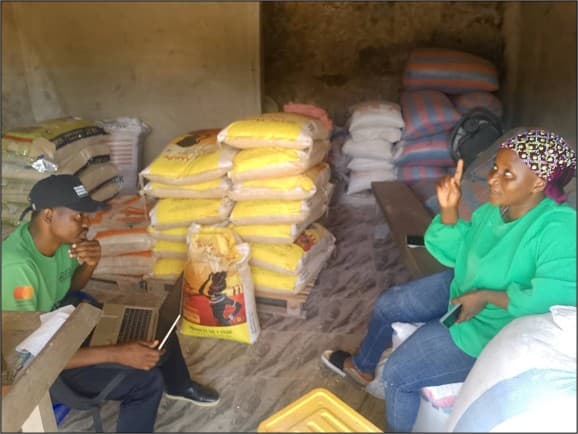 Anthony Agee-kum visiting Maria Seidu at her shop during a business field visit
