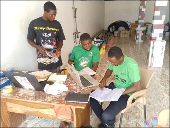 TTU Adwumawura official checking record keeping during a site visit